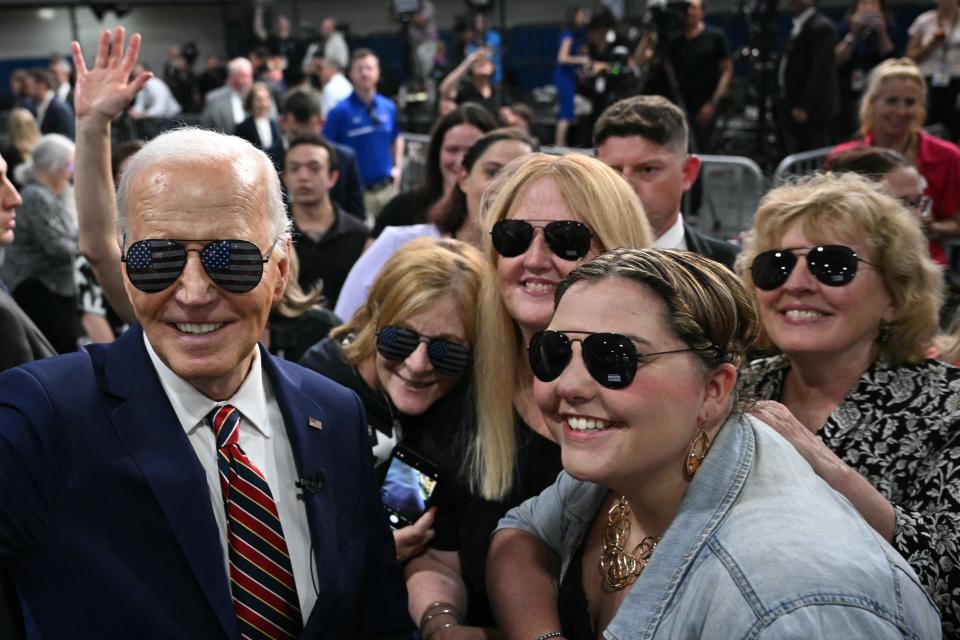 President Joe Biden wears sunglasses as he takes a selfie with supporters after speaking about the PACT Act, which expands coverage for veterans exposed to toxic substances, at a YMCA in Nashua, N.H. on May 21. But why won't Ohio officials welcome him on the November ballot?