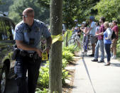 <p>A Minneapolis police officer puts up police tape following an explosion at Minnehaha Academy, Aug. 2, 2017, in Minneapolis. (David Joles/Star Tribune via AP) </p>