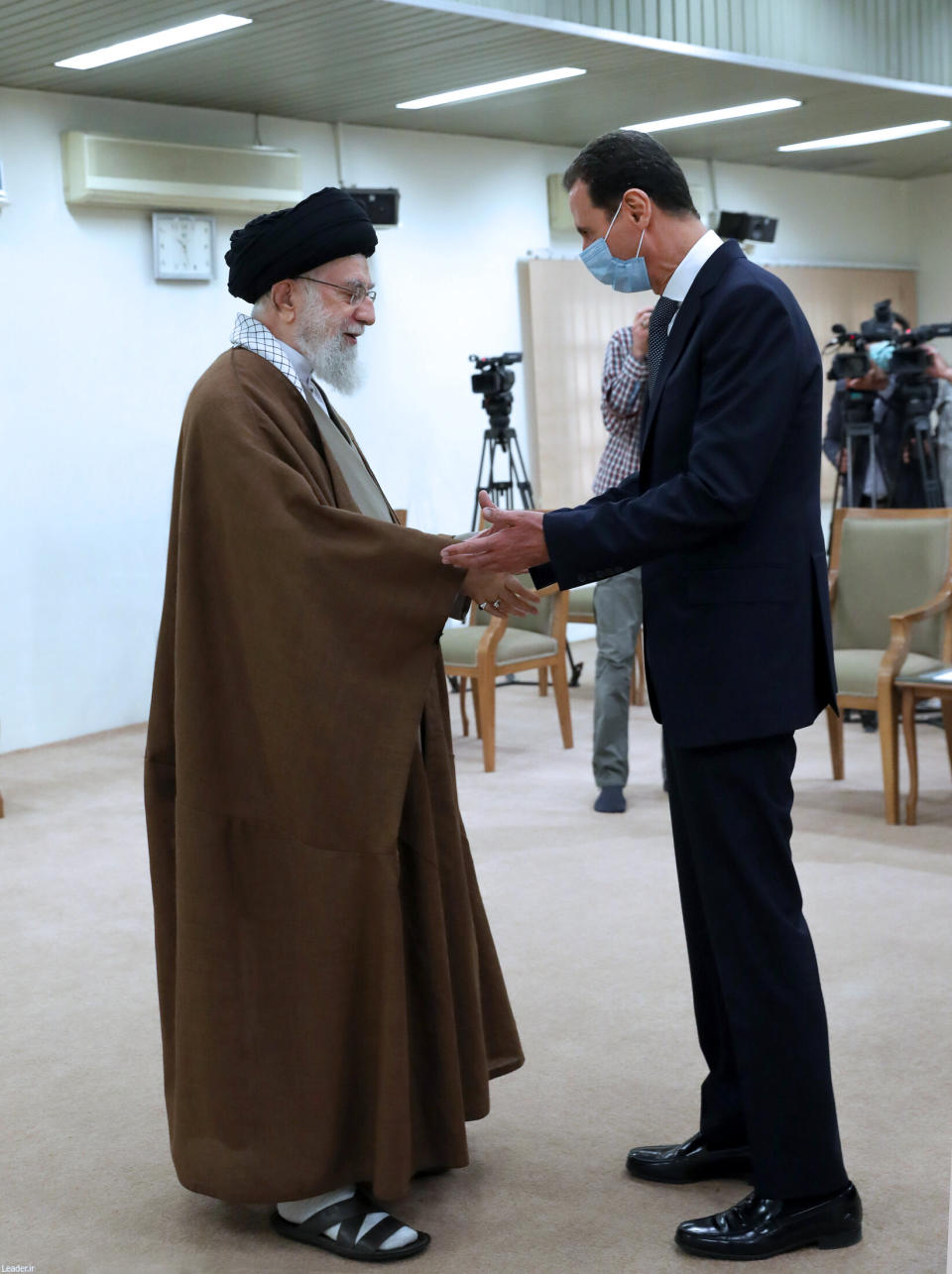 In this picture released by the official website of the office of the Iranian supreme leader, Supreme Leader Ayatollah Ali Khamenei, left, and Syrian President Bashar Assad shake hands at the start of their meeting, in Tehran, Iran, Sunday, May 8, 2022. Nour News, close to Iran's security apparatus, said in the Sunday report that Assad met Ayatollah Khamenei and President Ebrahim Raisi earlier in the day. (Office of the Iranian Supreme Leader via AP)