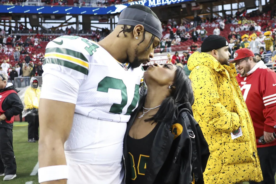 FILE - Green Bay Packers safety Jonathan Owens and Simone Biles kiss before an NFL football NFC divisional playoff game between the Packers and the San Francisco 49ers, on Jan. 20, 2024, in Santa Clara, Calif. Owens is taking a break from Chicago Bears training camp to come watch Biles at the Olympic women's gymnastics team final. Owens has been the target of criticism from some Biles' fans for comments he's made about their relationship (AP Photo/Jed Jacobsohn, File)