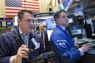 Trader Michael Zicchinolfi (L) waits for a price on the floor of the New York Stock Exchange April 21, 2014. REUTERS/Brendan McDermid