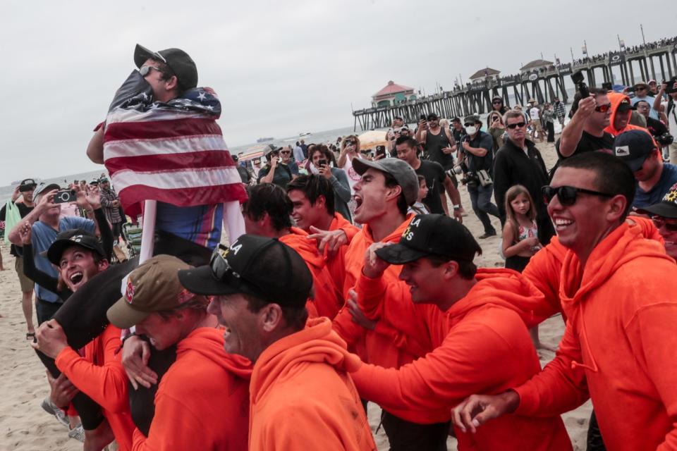 Griffin Colapinto is carried from the surf after winning the final