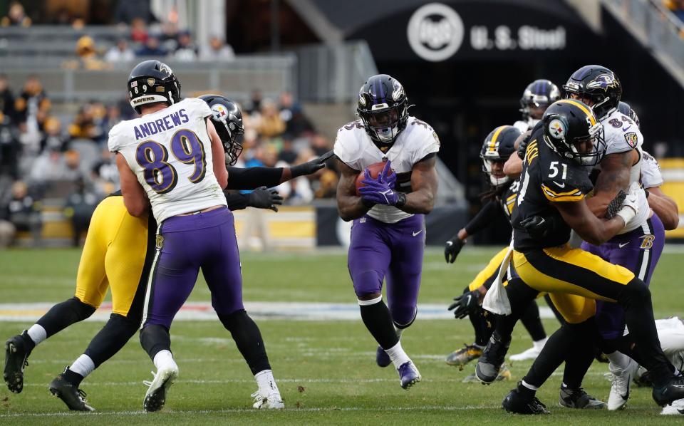 Baltimore Ravens running back Gus Edwards (35) runs the ball against the Pittsburgh Steelers during the fourth quarter at Acrisure Stadium.