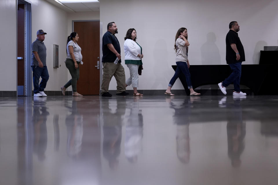 Families of the victims in the Uvalde elementary school shooting arrive for a news conference, Wednesday, May 22, 2024, in Uvalde, Texas. The families of 19 of the victims announced a lawsuit against nearly 100 state police officers who were part of the botched law enforcement response. The families say they also agreed a $2 million settlement with the city, under which city leaders promised higher standards and better training for local police. (AP Photo/Eric Gay)