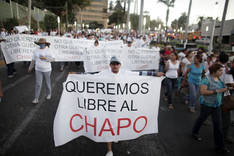 A protester holds a sign reading, 