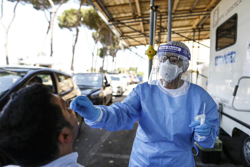 A man undergoes testing for COVID-19 at Rome's San Giovanni Addolorata hospital, Friday, Aug. 14, 2020. Italy is imposing mandatory testing on anyone arriving from Greece, Spain, Malta and Croatia as the number of new confirmed cases of coronavirus continues to nudge up with new cases recorded in every region of the country, often imported from abroad. (Cecilia Fabiano/LaPresse via AP)