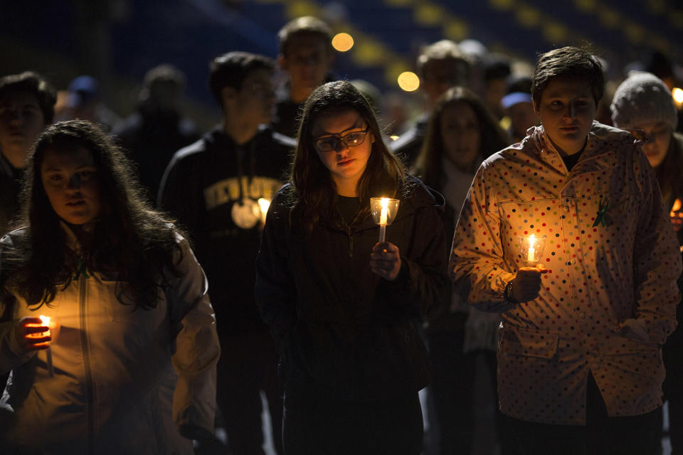 <p>Led by high school students, mourners walk around the track of the football field with candles during a community vigil at Newtown High School for the victims of last week’s mass shooting at Marjory Stoneman Douglas High School in Parkland, Fla., Feb. 23, 2018 in Newtown, Conn. Newtown is home to Sandy Hook Elementary School, where 26 people, 20 of them children, were killed in a mass shooting in 2012. (Photo: Drew Angerer/Getty Images) </p>