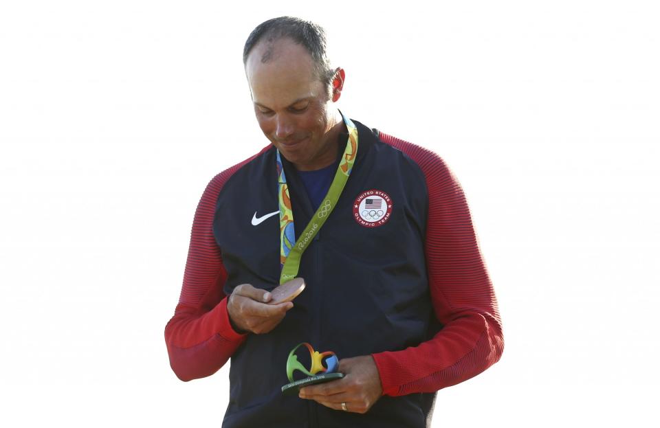 Matt Kuchar admires his bronze medal after making a late charge in the final round. (Reuters)