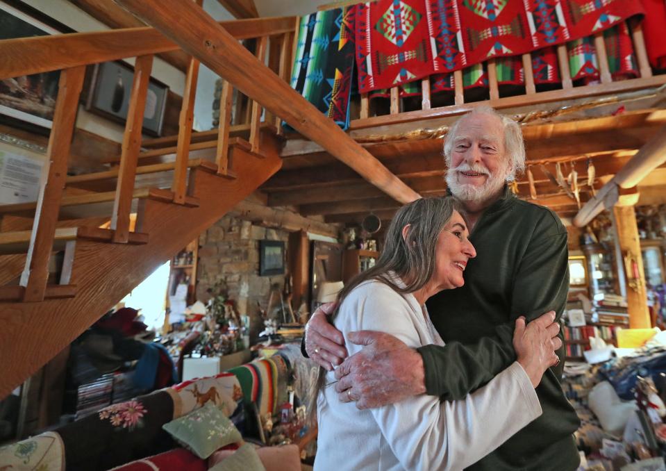 Dark Rain Thom, left, hugs her husband, James Alexander Thom in their home Wednesday, April 7, 2021 in Bloomington, IN. It is the 40th anniversary of the publication of James Alexander Thom's 1981 historical novel, "Follow the River."