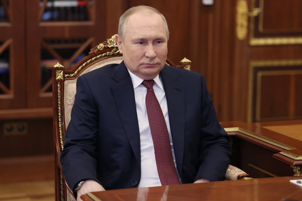 Russian President Vladimir Putin listens to Russia's commissioner for entrepreneurs' rights, Boris Titov during their meeting in the Kremlin in Moscow, Russia, Thursday, May 26, 2022