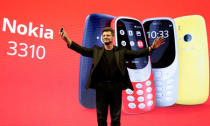 Arto Nummela, CEO of Nokia-HMD, holds up a Nokia 3310 device during a presentation ceremony at Mobile World Congress in Barcelona, Spain, February 26, 2017. REUTERS/Paul Hanna