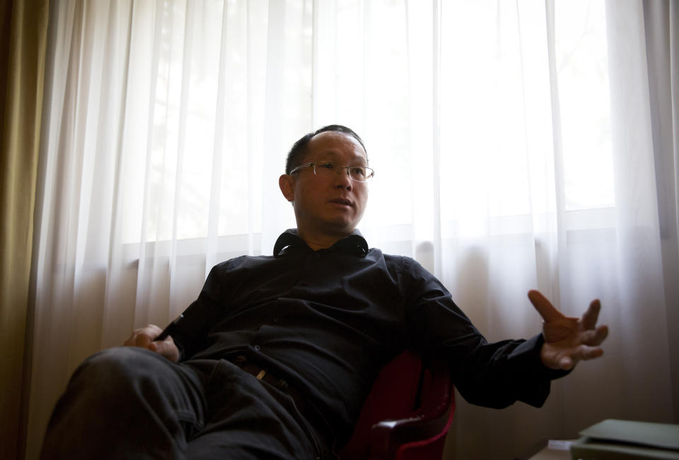 In this Saturday, April 12, 2014 photo, David Tang, a London-based lawyer working with U.K. firm Stewarts Law and an American firm, speaks during an interview at a hotel room in Beijing. Major disasters draw lawyers looking to sign up clients for big lawsuits, and the missing Malaysia Airlines Flight 370 with mostly Chinese passengers aboard has been no exception, with lawyers from various firms descending on a Beijing hotel where relatives have stayed and even traveling around China to visit them in their homes. Tang was in Beijing this past weekend meeting Chinese relatives at a hotel where they have been staying. When they meet, he shows the relatives an information sheet describing how insurance payments for loss of life differ according to nationality. (AP Photo/Andy Wong)