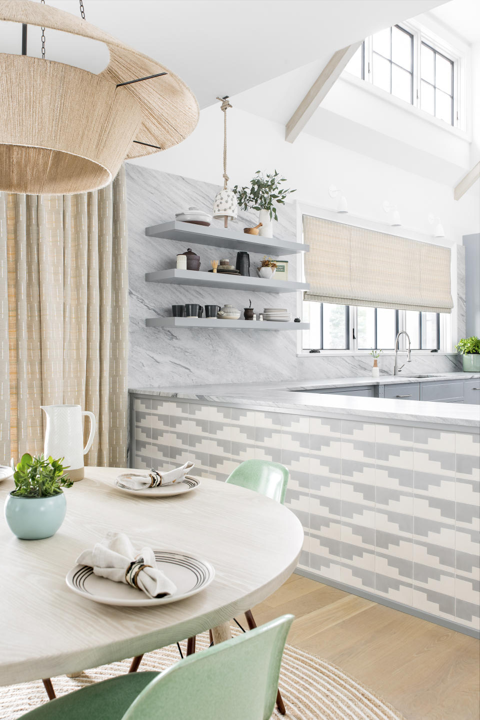 This image released by designer Cortney Bishop shows a kitchen outside of New York that was inspired by the owner's visit to Sullivan Island in South Carolina. The distinctive patterned tile is from Exquisite Surface’s Commune collection. (Cortney Bishop via AP)