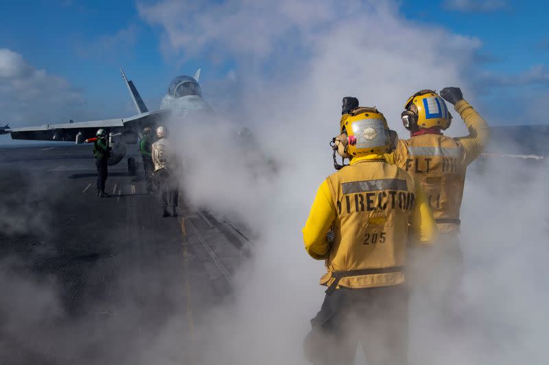 FILE PHOTO: An E/A-18G Growler is directed on the flight deck of the U.S. Navy aircraft carrier USS Nimitz