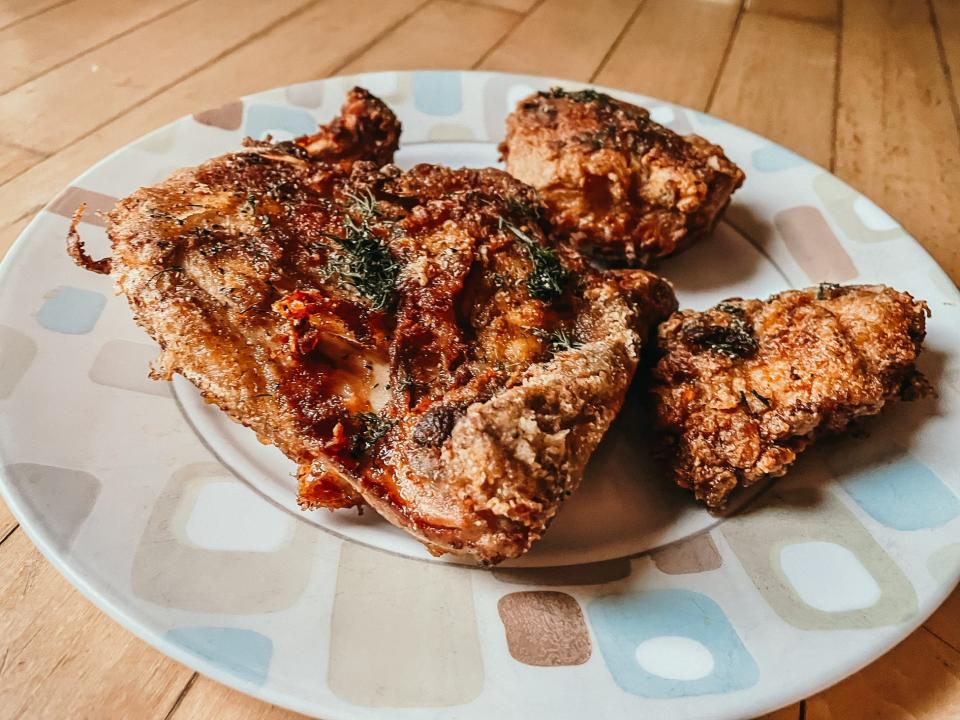 pieces of seasoned fried chicken on a plate