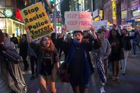 Protesters march near Times Square in the Manhattan borough of New York City calling for social, economic, and racial justice April 29, 2015. REUTERS/Mike Segar