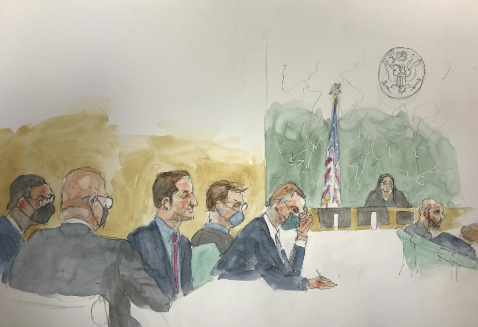 In this courtroom sketch, defendants Hernan Lopez, center, and Carlos Martinez, second from right, sit with their attorneys as the jury deliberates, Tuesday, March 7, 2023, at Brooklyn federal court in New York. The two former Fox executives are accused of paying tens of millions of dollars in bribes to gain broadcasting rights to soccer's biggest matches, including the World Cup. (Aggie Whelan Kenny via AP)