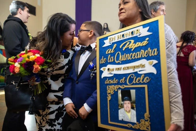 Raquel García, left, kisses her nephew, Memito, as they pose for pictures after Karina’s quinceañera Mass.