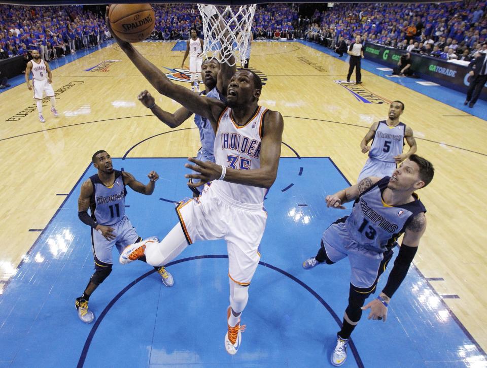 Oklahoma City Thunder forward Kevin Durant (35) shoots in front of Memphis Grizzlies guard Mike Conley (11), guard Tony Allen (9) and forward Mike Miller (13) in the second quarter of Game 7 of an opening-round NBA basketball playoff series in Oklahoma City, Saturday, May 3, 2014. (AP Photo/Sue Ogrocki)