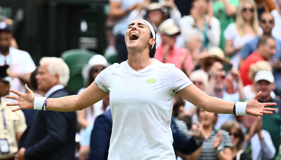 TOPSHOT - Tunisia's Ons Jabeur celebrates beating Kazakhstan's Elena Rybakina during their women's singles quarter-finals tennis match on the tenth day of the 2023 Wimbledon Championships at The All England Lawn Tennis Club in Wimbledon, southwest London, on July 12, 2023. (Photo by SEBASTIEN BOZON / AFP) / RESTRICTED TO EDITORIAL USE (Photo by SEBASTIEN BOZON/AFP via Getty Images)