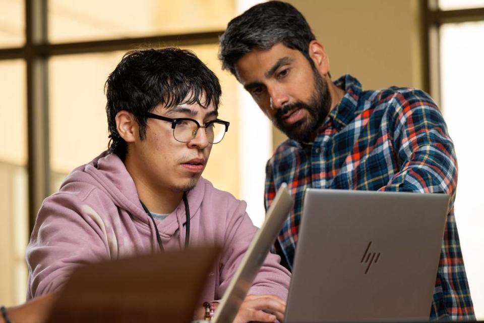 PNNL tech student Miguel Palomino and mentor Richard Saldanha, a physicist at PNNL, work on a project aimed to understand more about the nature of neutrinos.