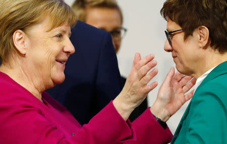 New CDU leader Annegret Kramp-Karrenbauer and German Chancellor Angela Merkel bid farewell to each other during the closing of Christian Democratic Union (CDU) party congress in Hamburg, Germany, December 8, 2018. REUTERS/Kai Pfaffenbach