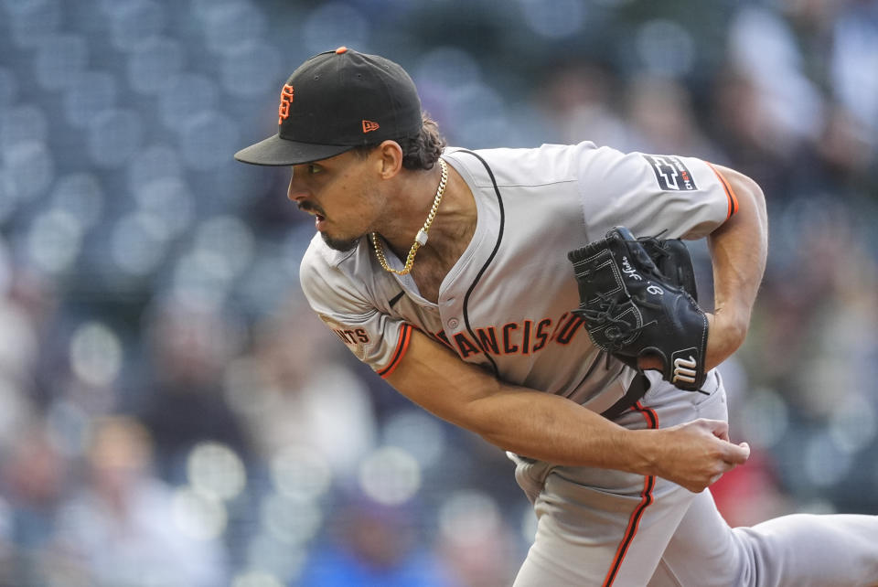 San Francisco Giants starting pitcher Jordan Hicks works against the Colorado Rockies during the first inning of a baseball game Wednesday, May 8, 2024, in Denver. (AP Photo/David Zalubowski)