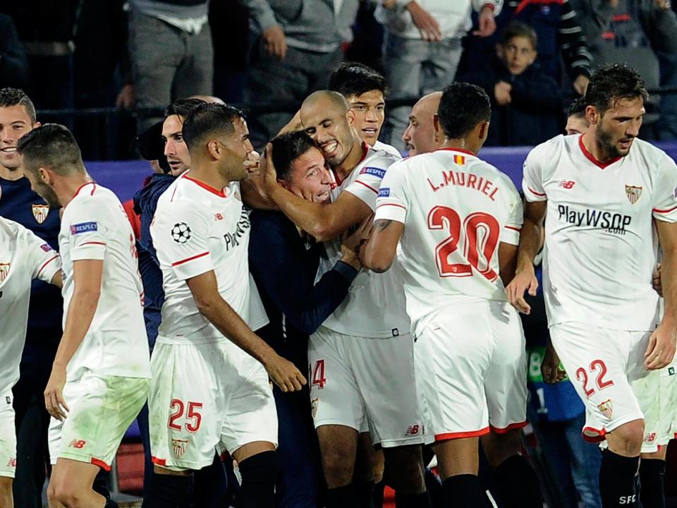 Sevilla's players celebrated with Eduardo Berizzo after equalising late on: Getty