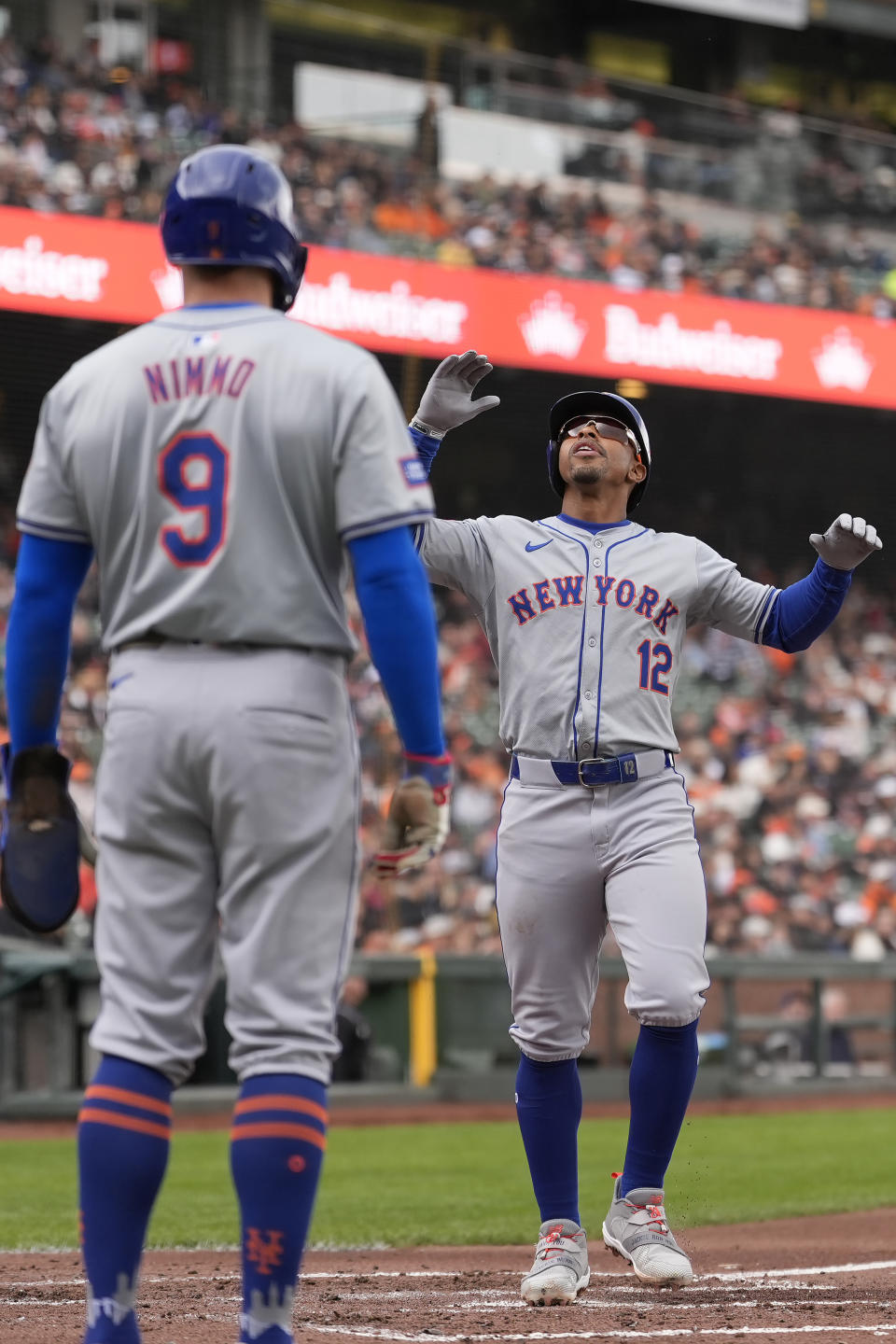 New York Mets' Francisco Lindor, right, celebrates after hitting a two-run home run that also scored Brandon Nimmo (9) against the San Francisco Giants during the third inning of a baseball game in San Francisco, Wednesday, April 24, 2024. (AP Photo/Jeff Chiu)