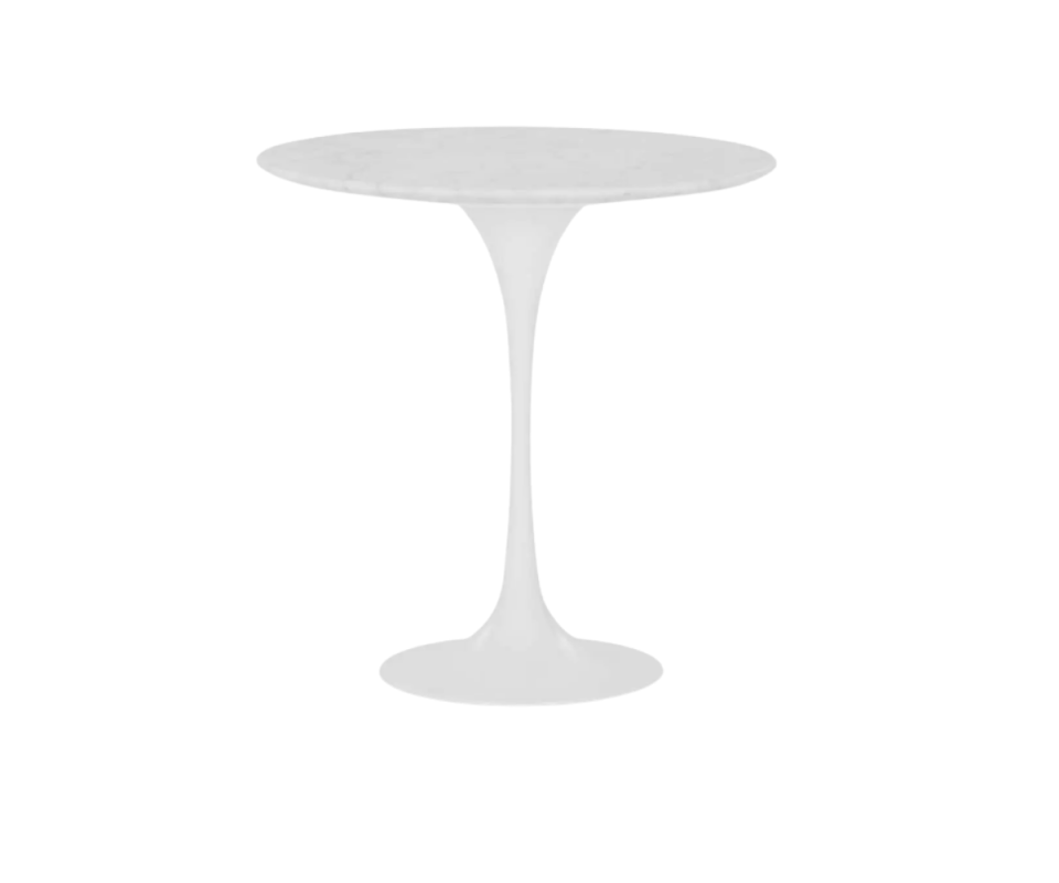 A white marble top tulip table stands against a white background.