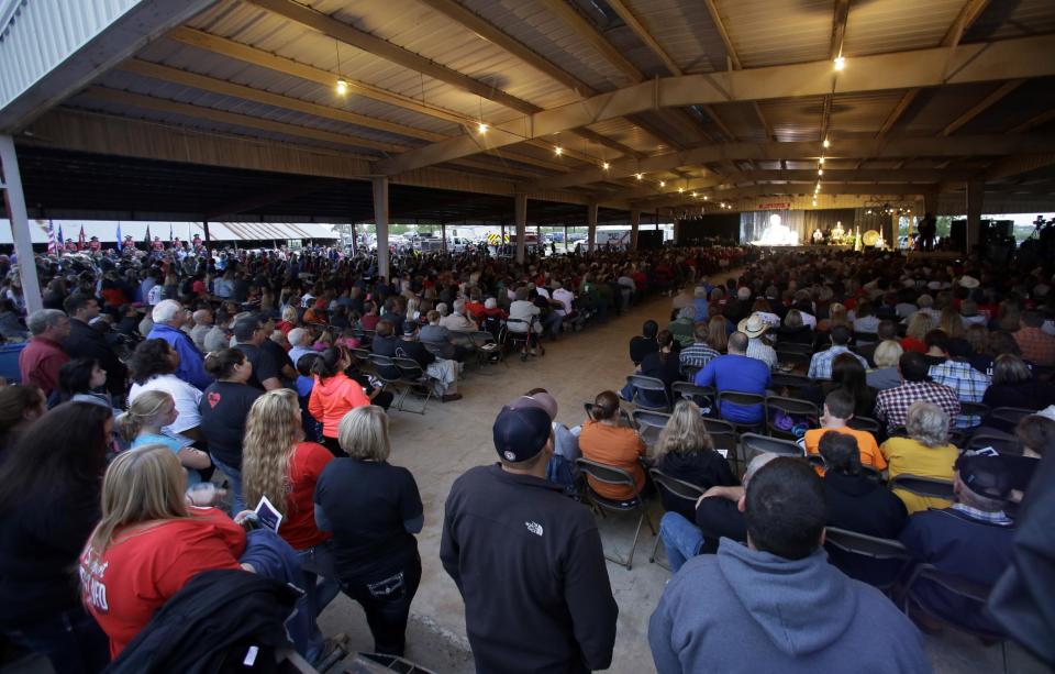 Thousands of people gather outside and under the roof of a pavilion for a memorial service, Thursday, April 17, 2014, in West, Texas. The service honored those killed by a fertilizer plant explosion one year ago. Fifteen people were killed, including 12 volunteer firefighters and others responding to the fire, and more than 200 were injured. (AP Photo/Tony Gutierrez)