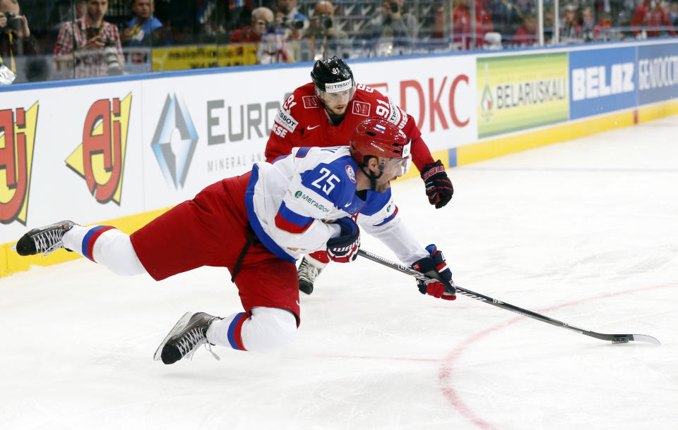 Russia's Danis Zaripov, front, is challenged by Switzerland's Robin Grossmann during the Group B preliminary round match between Switzerland and Russia at the Ice Hockey World Championship in Minsk, Belarus, Friday, May 9, 2014. (AP Photo/Darko Bandic)