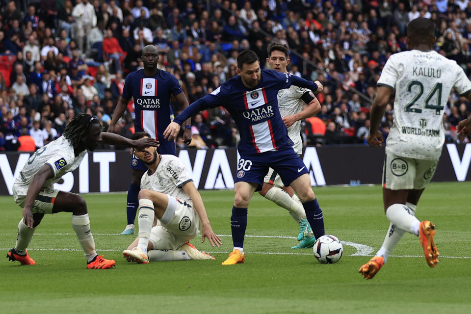 PSG's Lionel Messi dribbles players during the French League One soccer match between Paris Saint-Germain and Lorient, at the Parc des Princes stadium in Paris, Sunday, April 30, 2023. (AP Photo/Aurelien Morissard)