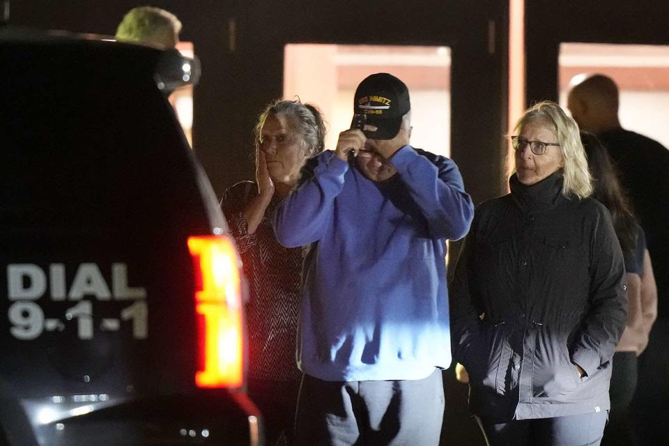 <p>AP Photo/Steven Senne</p> People depart a reunification center early Thursday, Oct. 26, 2023, at Auburn Middle School, in Auburn, Maine, after shootings in Lewiston.