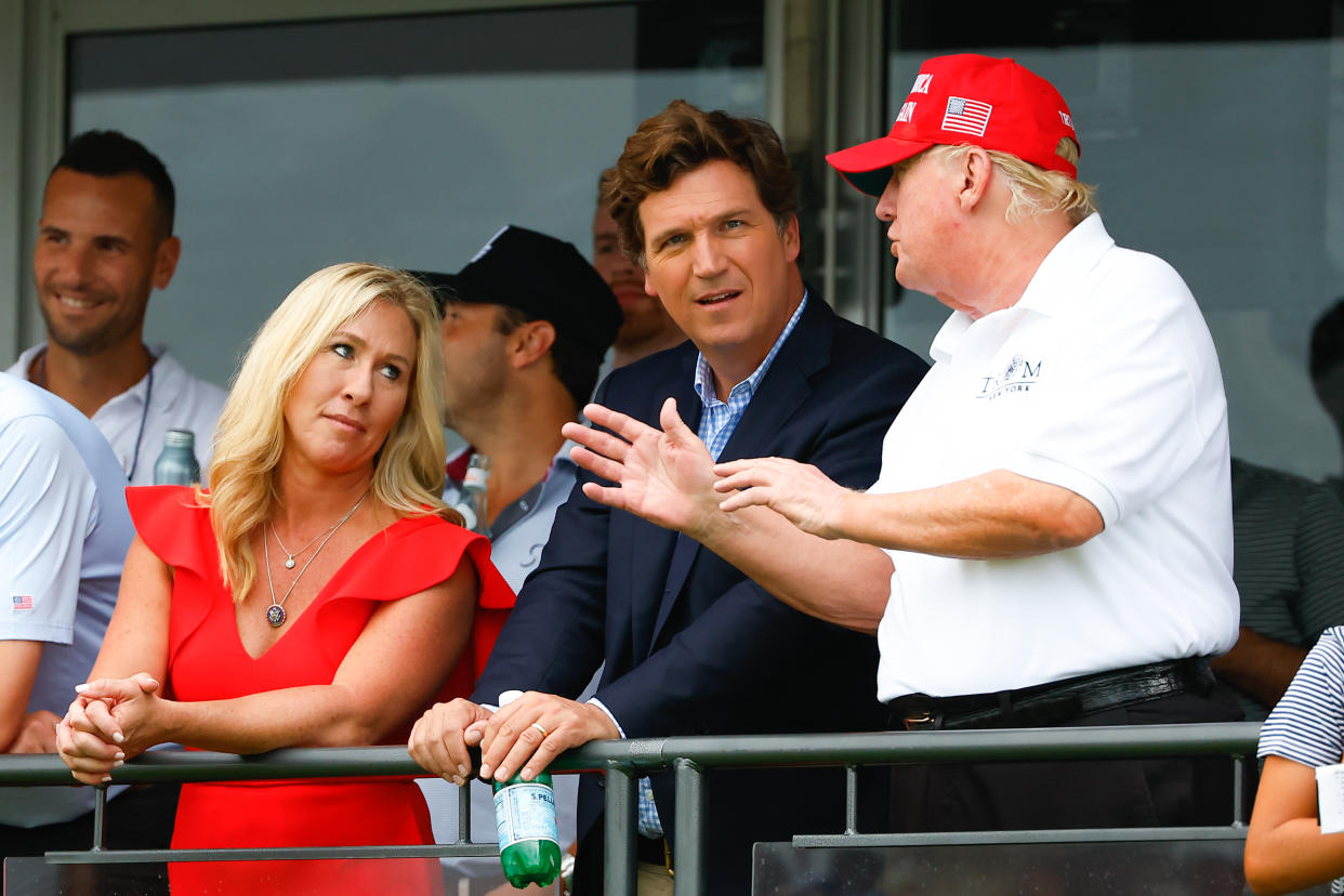 Tucker Carlson, center, with Donald Trump and Rep. Marjorie Taylor Greene