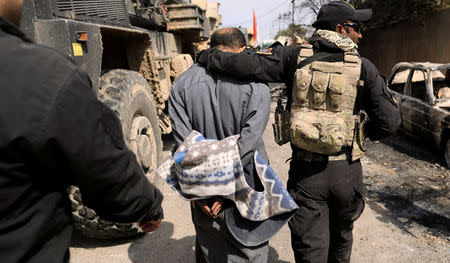 Iraqi Special Operations Forces detain a person suspected of belonging to Islamic State militants in western Mosul March 8, 2017. REUTERS/Zohra Bensemra