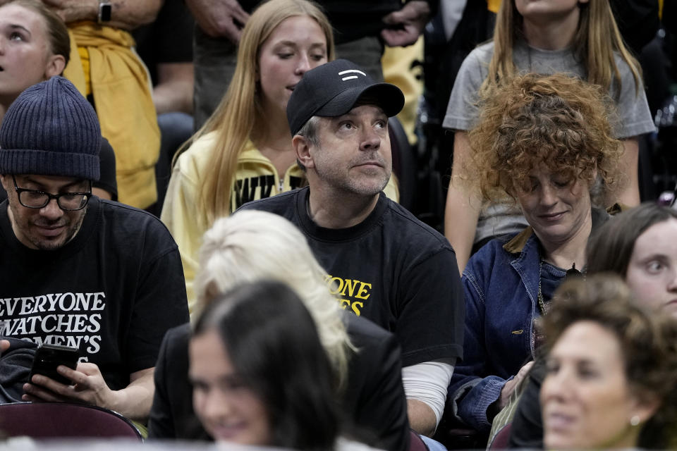 Actor Jason Sudeikis, center, watches the first half of the Final Four college basketball championship game between South Carolina and Iowa in the women's NCAA Tournament, Sunday, April 7, 2024, in Cleveland. (AP Photo/Morry Gash)