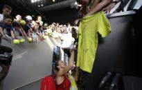 Tennis - Australian Open - Margaret Court Arena, Melbourne, Australia, January 22, 2018. Simona Halep of Romania signs autographs after winning against Naomi Osaka of Japan. REUTERS/Issei Kato