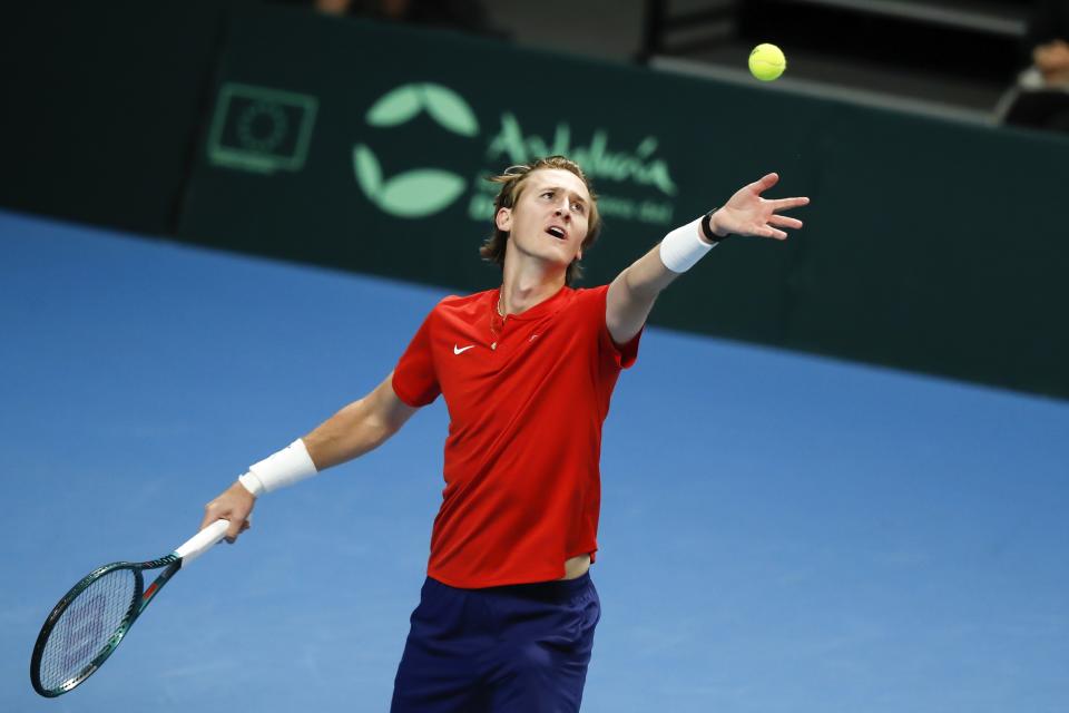Sebastian Korda of the USA tosses the ball as he serves to Oleksii Krutykh of Ukraine during a Davis Cup qualifier tennis match between Ukraine and USA in Vilnius, Lithuania, Thursday, Feb. 1, 2024. (AP Photo/Mindaugas Kulbis)