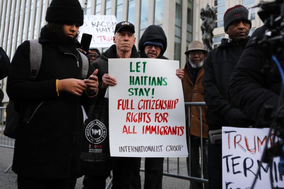 NEW YORK, NEW YORK – JANUARY 07: People demonstrate as a trial begins to try to protect Haitians immigrants under the Temporary Protected Status (TPS) from being deported back to Haiti in front of the Eastern District of New York Federal Courthouse in downtown Brooklyn on January 07, 2019 in New York City. President Donald Trump is trying to end TPS for Haitians which was granted to them following the 2010 7.0 magnitude earthquake which decimated the island nation and resulted in the death of 250,000 Haitians. TPS allows immigrants to work and live in the United States following a natural disaster or an ongoing armed conflict in their home country. (Photo by Spencer Platt/Getty Images)