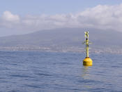 In this photo taken on Sunday May 3, 2020, a buoy floats in the Gulf of Naples, Italy. Preliminary results from a survey of seawater quality during Italy’s coronavirus lockdown indicate a sharp reduction in pollution from human and livestock waste in the seas off Rome. Authorities stressed it was too soon to give the lockdown sole credit for the change. They say shifting sea currents and limited rainfall in April and May also could have reduced runoff from agriculture. (AP Photo/Paolo Santalucia)