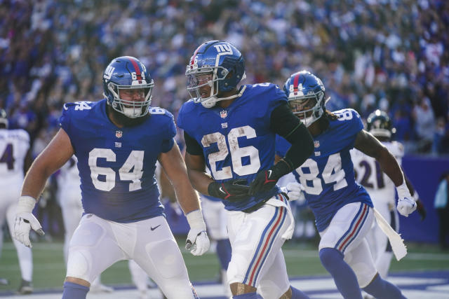 Baltimore Ravens running back J.K. Dobbins (27) runs with the ball against  the New York Giants during an NFL football game Sunday, Oct. 16, 2022, in  East Rutherford, N.J. (AP Photo/Adam Hunger