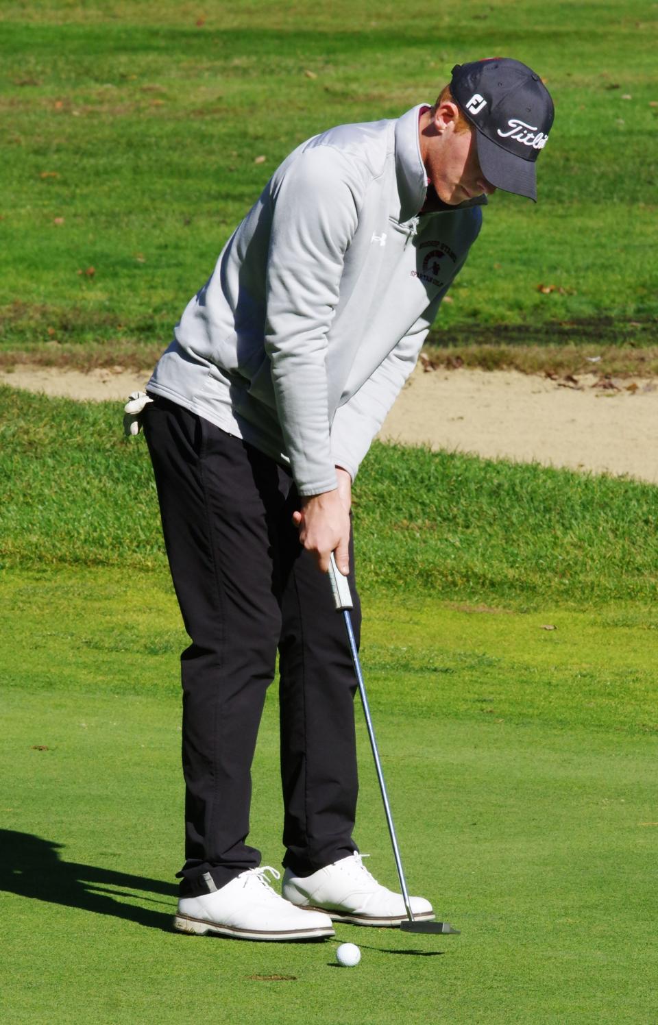 Matthew Costello of Bishop Stang makes a tap in putt on the 12th hole during MIAA Tourney play at the Easton Country Club on Tuesday, Oct. 24, 2023.