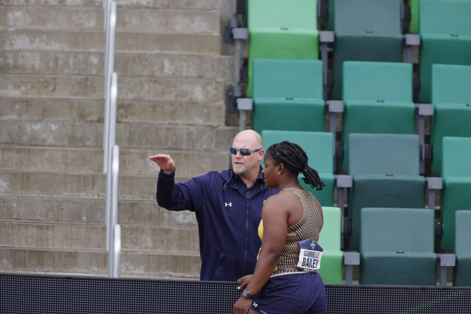 Coach Nathan Fanger instructs Gabrielle Bailey at the 2022 NCAA National Outdoor Track and Field Championships in Eugene, Ore., June 8-11, 2022.