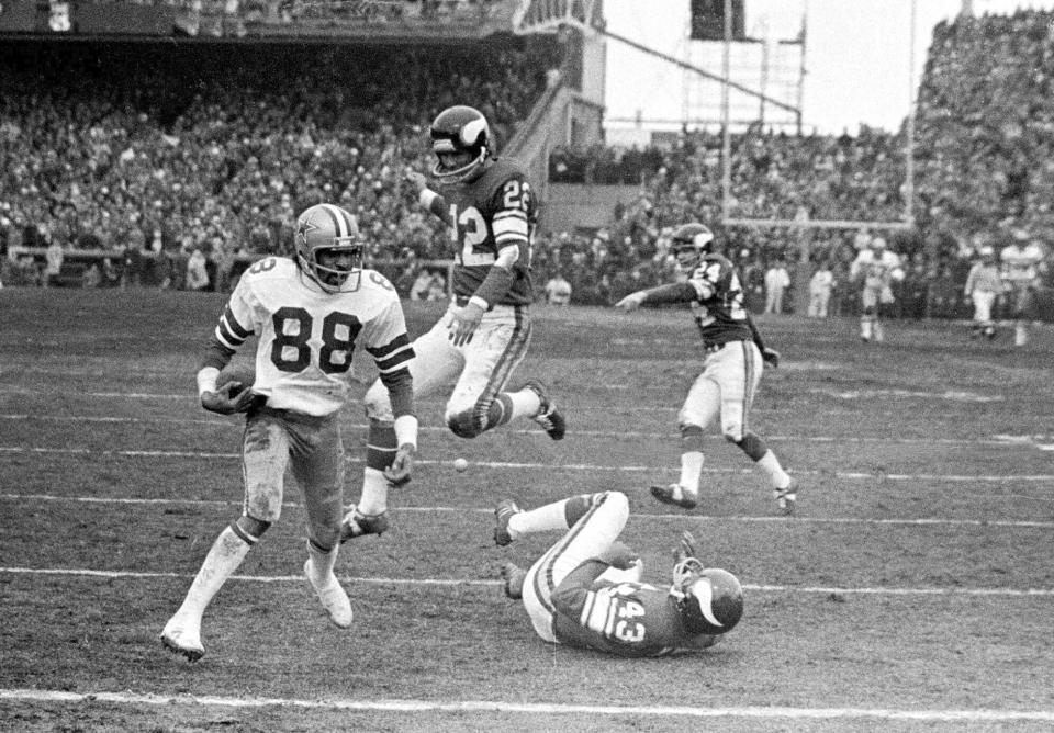 FILE - In this Dec. 28, 1975, file photo, Dallas Cowboy wide receiver Drew Pearson (88) nears the end zone on a game-winning 50-yard touchdown pass play in the fourth quarter of an NFL football game against the Minnesota Vikings in Bloomington, Minn. Cowboys quarterback Roger Staubach explained his game-winning throw by saying, "I closed my eyes and said a Hail Mary. Staubach and Pearson have connected again as part of a project to create a digital collectible of their famous Hail Mary for the Dallas Cowboys against Minnesota in 1975. It's part of an emerging product in sports memorabilia called non-fungible tokens, or NFTs.