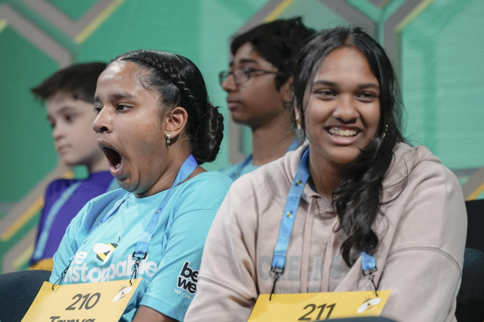 Tanya Kadaru, 13, left, of Keller, Texas, yawns during the quarterfinals of the Scripps National Spelling Bee, in Oxon Hill, Md., Wednesday, May 29, 2024. (AP Photo/Mariam Zuhaib)