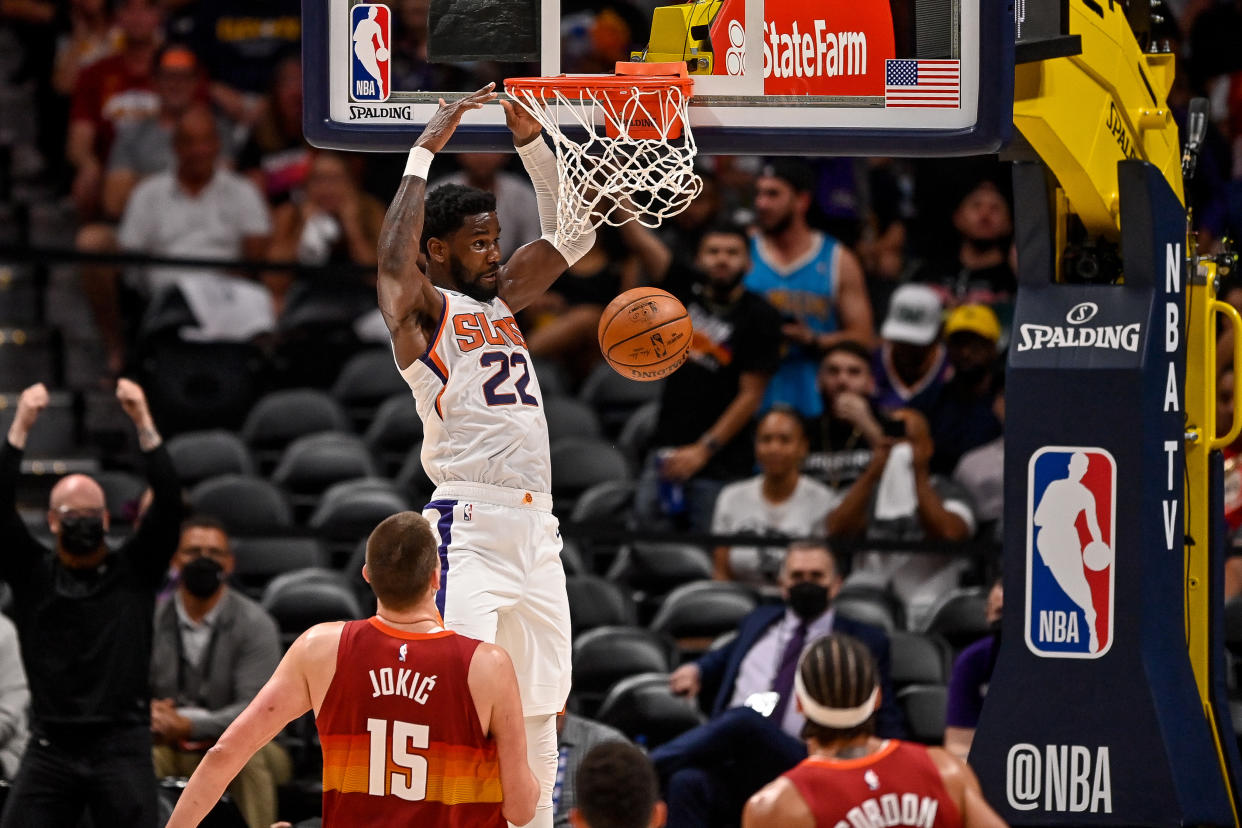 DENVER, CO - JUNE 13:  Deandre Ayton #22 of the Phoenix Suns scores on a slam dunk against the Denver Nuggets in Game Four of the Western Conference second-round playoff series at Ball Arena on June 13, 2021 in Denver, Colorado. NOTE TO USER: User expressly acknowledges and agrees that, by downloading and or using this photograph, User is consenting to the terms and conditions of the Getty Images License Agreement. (Photo by Dustin Bradford/Getty Images)