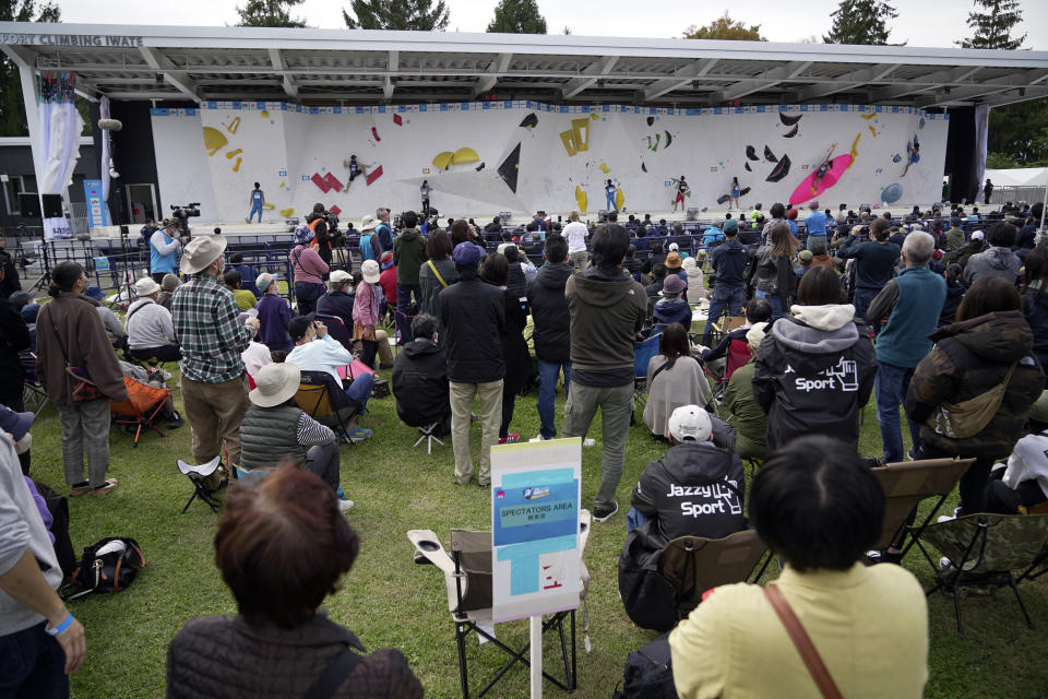 Visitors watch the women's and men's boulder semi-final of the IFSC Climbing World Cup Friday, Oct. 21, 2022, in Morioka, Iwate Prefecture, Japan. After Iranian climber Elnaz Rekabi joined a growing list of female athletes who have been targeted by their governments for defying authoritarian policies or acting out against bullying, a number of others have spoken out on their concerns of politics crossing into their sporting world. (AP Photo/Eugene Hoshiko)