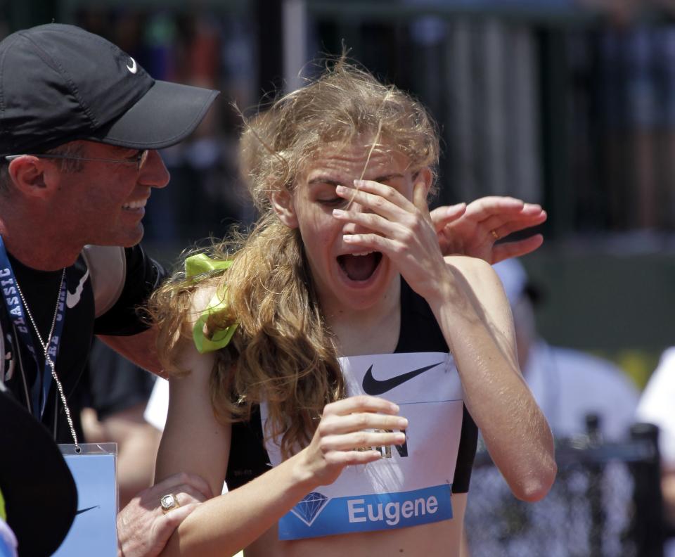 FILE - In this June 1, 2013, file photo, Mary Cain, 17, right, reacts as coach Alberto Salazar tells her she has just broken the American high school 800-meter record during the Prefontaine Classic track and field meet in Eugene, Ore. Nike will investigate allegations of abuse by runner Mary Cain while she was a member of Alberto Salazar's training group. Cain joined the disbanded Nike Oregon Project run by Salazar in 2013, soon after competing in the 1,500-meter final at track and field's world championships when she was 17. (AP Photo/Don Ryan, File)