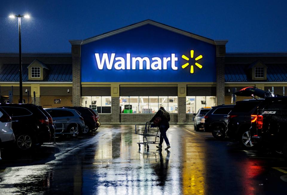 A shopper pushes a cart through the parking lot of a Walmart on the morning of Black Friday in Wilmington, Delaware, on November 25, 2022. Walmart raised its full-year forecast on August 17, 2023, following a jump in quarterly profits, pointing to solid increases at US stores and e-commerce. The big retailer, which has been seen as well positioned amid inflation because of its reputation for value, enjoyed another quarter of growing sales.